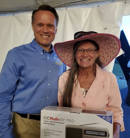 STR listener, Maize Grace (right) with her new radio at the STR drawing last June during camp meeting. The Lord provided after Maize's radio had failed!